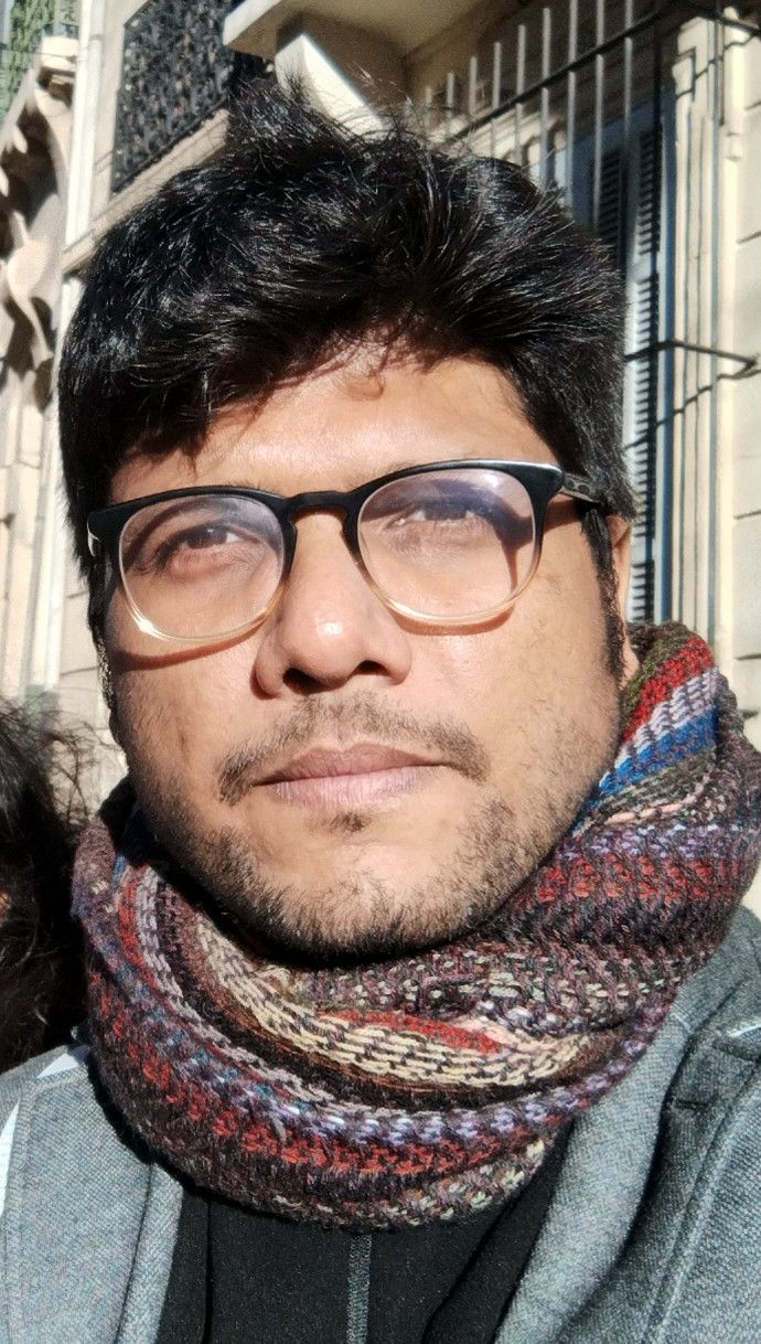 Portrait of Anurag outdoors in a knit scarf.